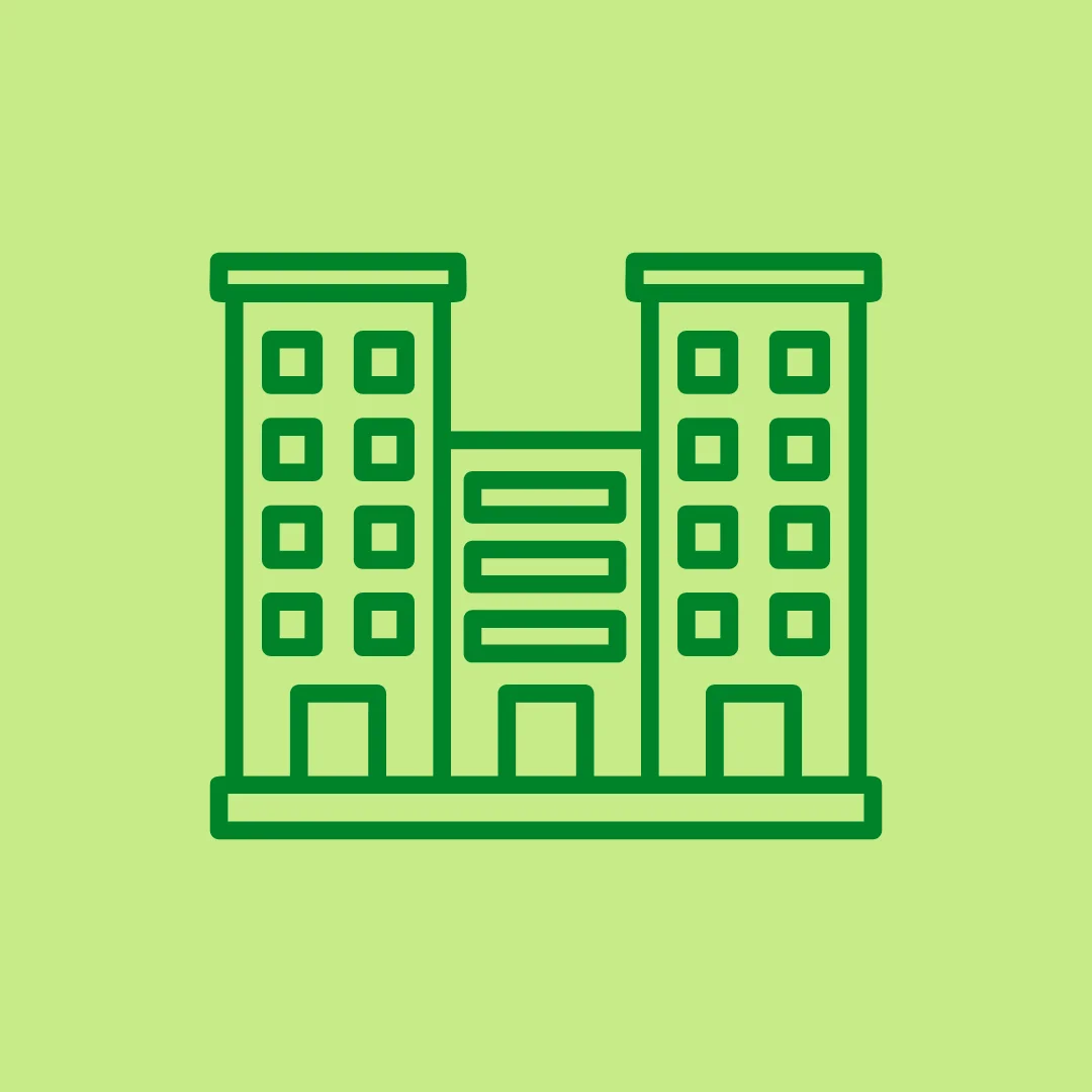 Commercial building icon with green background.